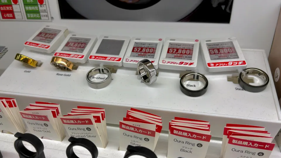 Oura Ring 4 smart rings in gold, rose gold, silver, black and stealth on a store display